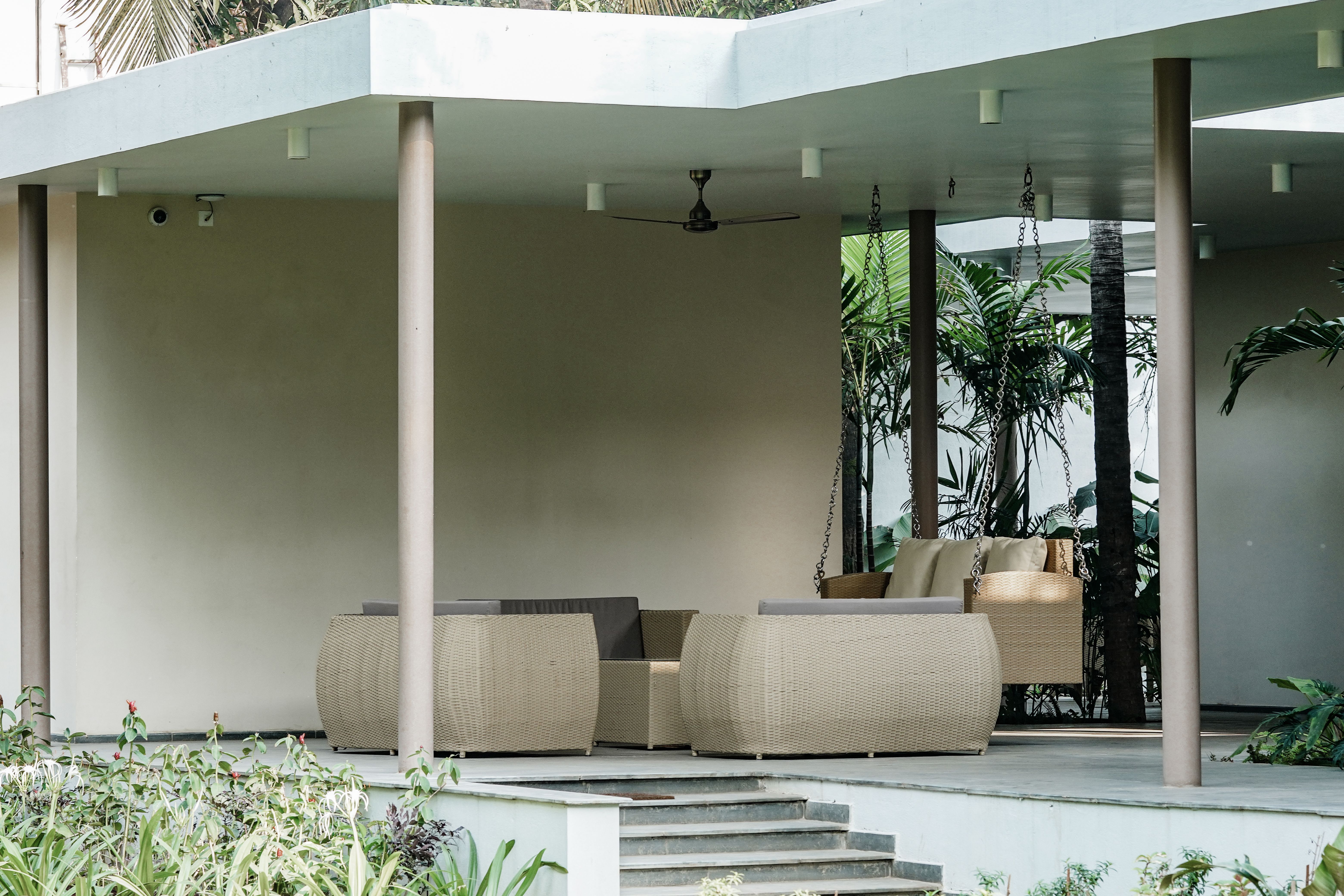 Spacious outdoor patio with modern wicker furniture for relaxing summer afternoons